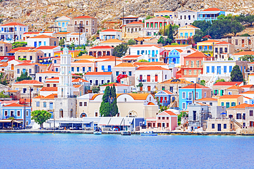 View of Emporio harbour and Saint Nicholas church in the distance, Emporio, Halki Island, Dodecanese Islands, Greek Islands, Greece, Europe