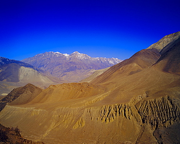 Arid landscape and colourful mountains, on route from KaGBeni to Khingar, Southern Mustang, Nepal