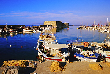 Fishing boats and Venetian fortress at Iraklion old harbour, Crete, Greece