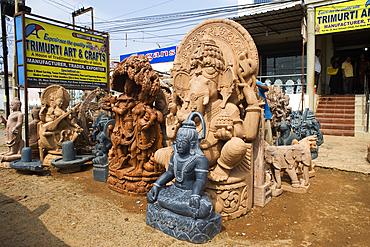 Statues of Hindu deities on view in front of a roadside trader's shop in Bhubaneswar, Odisha, India, Asia