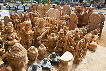 Statues of Hindu deities on view in front of a roadside trader's shop in Bhubaneswar, Odisha, India, Asia