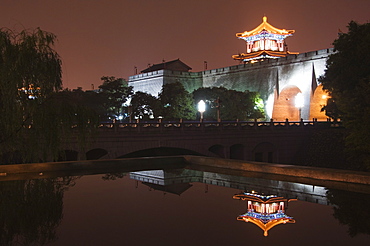 City wall and watch tower reflected in water, built during the first reign of Hongwu the first emperor of the Ming dynasty, Xian City, Shaanxi Province, China, Asia