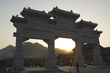 Sunset at the entrance gate to Shaolin temple, birthplace of Kung Fu martial art, Shaolin, Henan Province, China, Asia