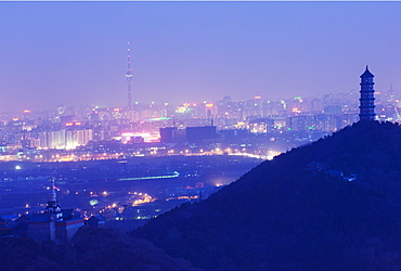 A Tibetan style stupa and pagoda on the grounds of Yuquan mountain overlooking the city and the CCTV tower, Haidian district, Beijing, China, Asia