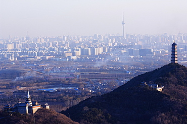 A Tibetan style stupa and pagoda on the grounds of Yuquan mountain overlooking the city and the CCTV tower, Haidian district, Beijing, China, Asia