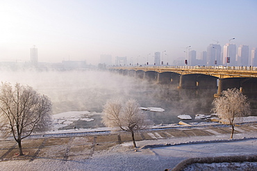 Mist rising off Songhua River and ice covered trees in winter, Jilin City, Jilin Province, Northeast China, China, Asia