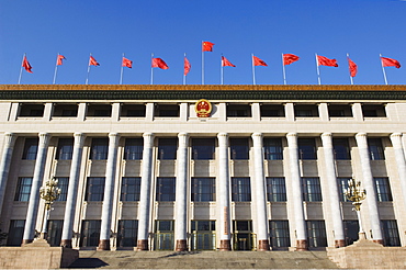 Chinese national flags on a government building Tiananmen Square Beijing China