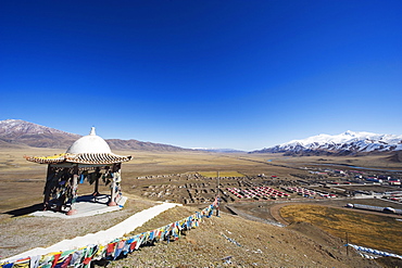 Prayer flags and sacred site overlooking the town of Bayanbulak, Xinjiang Province, China, Asia