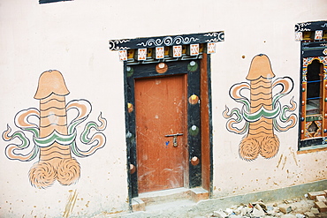 Phallic painting on a wall, at a town near the temple of the Divine Madman, Metshina, Punakha, Bhutan, Asia