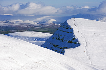 Hikers on snow covered Pen y Fan mountain, Brecon Beacons National Park, Powys, South Wales, United Kingdom, Europe