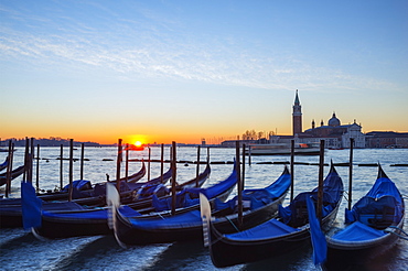 Gondolas and San Giorgio Maggiore Church across Bacino di San Marco, sunrise on Venice lagoon, Venice, UNESCO World Heritage Site, Veneto, Italy, Europe