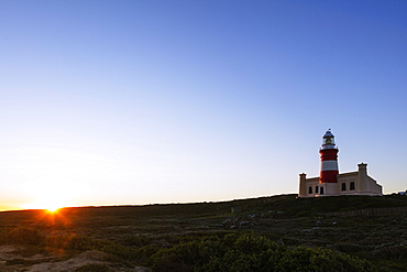 Agulhas lighthouse at southernmost tip of Africa at sunset, Agulhas National Park, Western Cape, South Africa, Africa