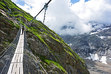 Hiker on a suspension bridge, Chamonix, Rhone Alpes, Haute Savoie, France, Europe