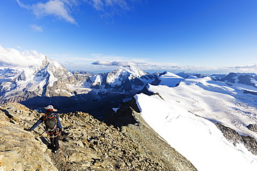 Climber on south ridge of Dent Blanche, 4357m, with view to the Matterhorn, Valais, Swiss Alps, Switzerland, Europe