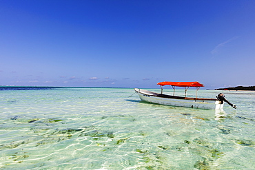 Small boat in crystal clear water, Pingwe, Island of Zanzibar, Tanzania, East Africa, Africa