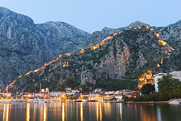 Venetian built fort with bastions highlighted by lights at twilight, Kotor, Montenegro, Europe