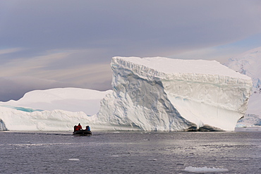 Tourists exploring Skontorp Cove in inflatable boat, Paradise Bay, Antarctica, Polar Regions