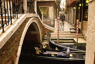 Gondolas beside a bridge, Venice, Veneto, Italy, Europe