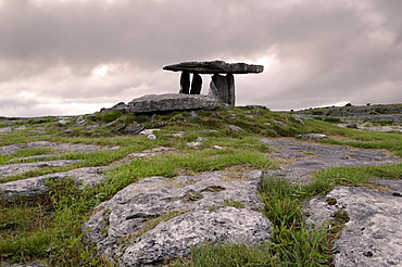 Moody sky over Poulnabrone Dolmen Portal Megalithic tomb at dusk, The Burren, County Clare, Munster, Republic of Ireland (Eire), Europe