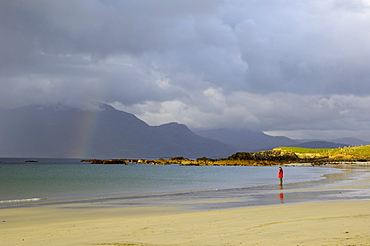 Lone person on a sandy beach under a stormy sky, near Tully Cross, Connemara, County Galway, Connacht, Republic of Ireland, Europe