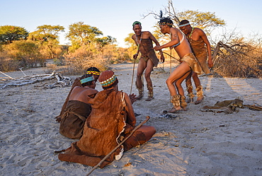 San Bushmen dancing and playing games around a fire, Kalahari, Botswana, Africa