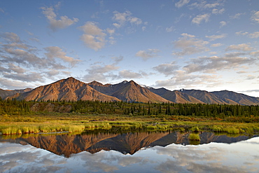 Mountains reflected in a pond along the Denali Highway, Alaska, United States of America, North America