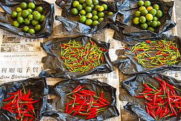 Red chilli peppers and limes, food market, Kuching, Sarawak, Malaysian Borneo, Malaysia, Southeast Asia, Asia