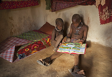 Himba children reading, Kaokoland, Namibia, Africa