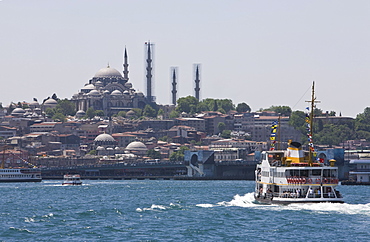 Ferry boat on Bosphorus with the Suleymaniye Mosque in the distance, Istanbul, Turkey, Europe