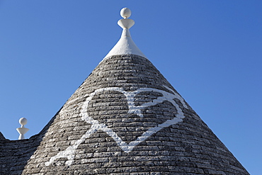 Heart painted on roof of traditional trullo in Alberobello, UNESCO World Heritage Site, Puglia, Italy, Europe