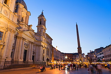 Tourists enjoying Bernini's Fontana dei Quattro Fiumi (Fountain of Four Rivers) in Piazza Navona, Rome, Lazio, Italy, Europe