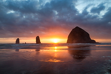 Sunset behind Haystack Rock at Cannon Beach on the Pacific Northwest coast, Oregon, United States of America, North America