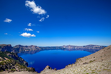 The still waters of Crater Lake, the deepest lake in the U.S.A., part of the Cascade Range, Oregon, United States of America, North America