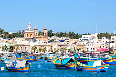 Traditional brightly painted fishing boats in the harbour at Marsaxlokk, Malta, Mediterranean, Europe