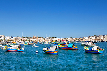 Traditional brightly painted fishing boats in the harbour at Marsaxlokk, Malta, Mediterranean, Europe