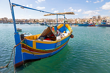 Traditional brightly painted fishing boat in the harbour at Marsaxlokk, Malta, Mediterranean, Europe