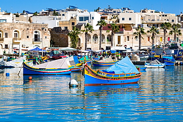 Traditional brightly painted fishing boats in the harbour at Marsaxlokk, Malta, Mediterranean, Europe