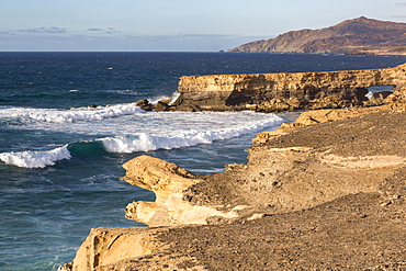 Surf and natural arch on Playa La Pared on the volcanic island of Fuerteventura, Canary Islands, Spain, Atlantic, Europe