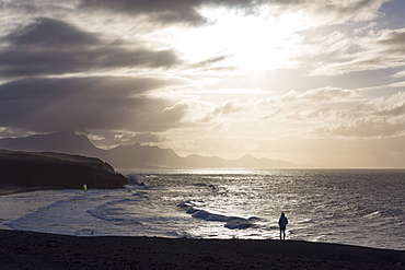 Lone man looking at the dramatic coastline of Playa del Viejo Rey near La Pared on the volcanic island of Fuerteventura, Canary Islands, Spain, Atlantic, Europe