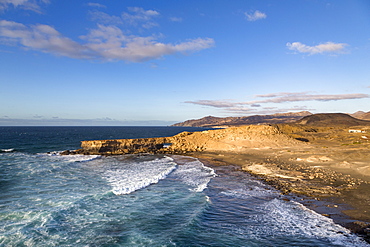 Surf and natural arch on Playa La Pared on the volcanic island of Fuerteventura, Canary Islands, Spain, Atlantic, Europe