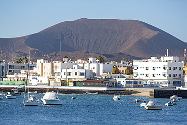 The waterfront of old town Corralejo on the island of Fuerteventura with a volcano in the distance, Fuerteventura, Canary Islands, Spain, Atlantic, Europe