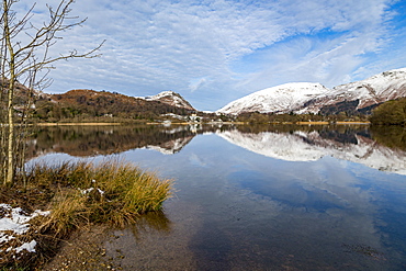 Shoreline and perfect reflection of snow covered mountains and sky in the still waters of Grasmere, Lake District National Park, UNESCO World Heritage Site, Cumbria, England, United Kingdom, Europe