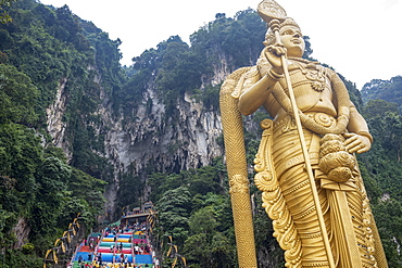 The tall golden Hindu statue of Murugan in front of the 272 steps to the Batu Caves with temples and shrines, near Kuala Lumpur, Malaysia, Southeast Asia, Asia