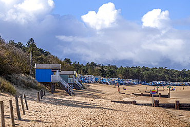 A row of colourful beach huts on the sand at Wells next the Sea in North Norfolk