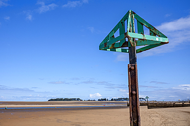 Channel marker and the expansive sandy beach at Wells next the Sea in North Norfolk