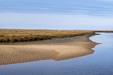The banks of the River Glaven, with marshes beyond, at Blakeney in North Norfolk