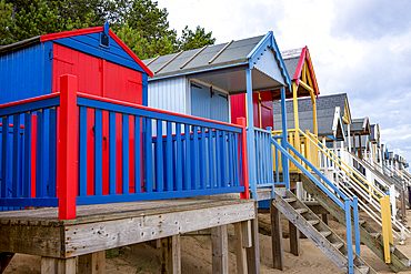A row of colourful beach huts on the sand at Wells next the Sea in North Norfolk