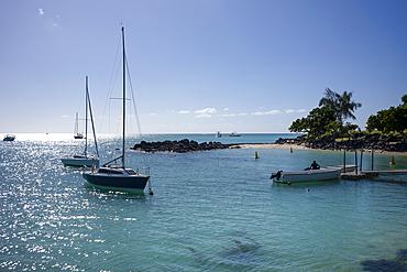 Boats moored in a beautiful small bay near la Cuvette View Point in Grand Baie on the exotic island of Mauritius in the Indian Ocean.