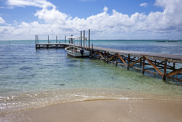 Boat moored at the jetty on Ile aux Cerfs on the exotic island of Mauritius in the Indian Ocean