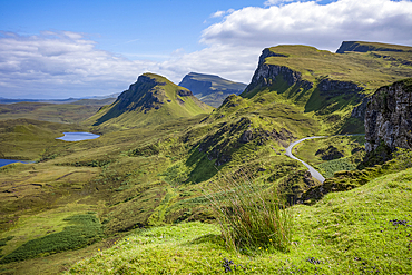 Narrow road running through the rugged hills of the Trotternish escarpment on the northernmost peninsula of the Isle of Skye, Inner Hebrides, Scotland.